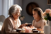 Niece giving cakes to grandma AI generated image