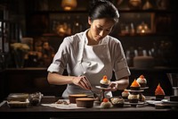 Asian female patissier making cake 