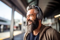 Happy senior man listening to music at bus stop AI generated image