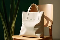 Tote bag on wooden table, natural light. 