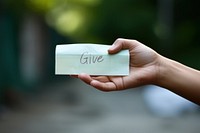 Hand holding paper, writing give word. AI generated Image by rawpixel.