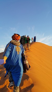 Hikers on sand dunes. Free public domain CC0 photo.