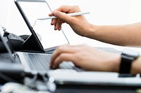 Businessman writing on tablet screen