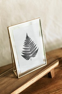 Aesthetic gold picture frame mockup psd, pressed leaf