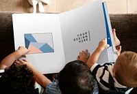 Toddlers reading a book mockup