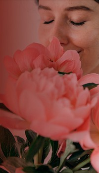 Woman smelling flower iPhone wallpaper, pink design