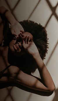 Woman iPhone wallpaper, laying on the ground, window shadow image