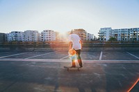 Skateboarder rides his board on a rooftop