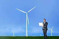 Wind turbine background, businessman using laptop image