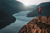 Man standing cliff background, nature travel image