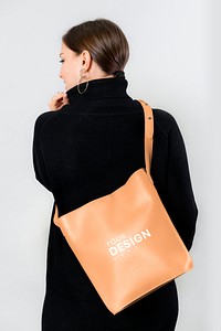Woman from behind with a brown crossbody bag mockup