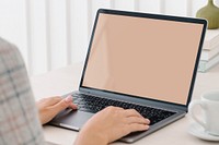 Person working on laptop, blank screen 