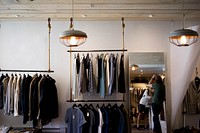 Racks with men's apparel on the walls of a clothes store. Original public domain image from Wikimedia Commons