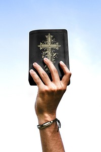 Hand holding bible book