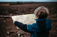 Little boy holding map