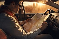 Man reading map in a car. 