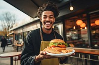 Cheerful holding burger bread. 