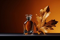 Perfume bottle leaf autumn. AI generated Image by rawpixel.