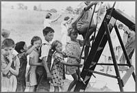 Farm children climbing chute-the-chutes, Southeast Missouri Farms Project school by Russell Lee