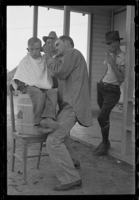 [Untitled photo, possibly related to: Community barber shop in Kern County migrant camp, California]. Sourced from the Library of Congress.