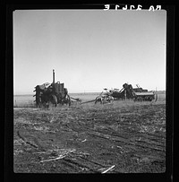 Discouraged farmers have been leaving this area over a period of years, leaving their heavy equipment in the fields. Mills, New Mexico. Sourced from the Library of Congress.