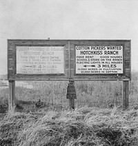 Employment signs in Spanish and English. These ranches (1938) increasingly use  pickers. Near Fresno, California. Sourced from the Library of Congress.