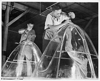 [Untitled photo, possibly related to: Manpower.  bomber plant workers. American manpower draws its skills from various racial groups alike. Here, in a large Eastern bomber plant, huge transparent plastic bomber noses are being conditioned for installation on planes which will carry America's offensive to the far conrers of the world. Glenn L. Martin Bomber Plant. Baltimore, Maryland]. Sourced from the Library of Congress.