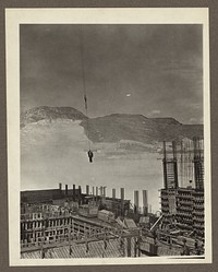 Grand Coulee Dam, Columbia Basin Reclamation Project, Wash. Two riggers on a hook on their way to work at the powerhouse on the right. Sourced from the Library of Congress.