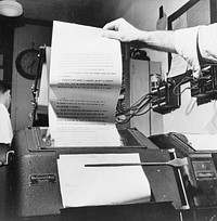 New York, New York. Wire room of the New York Times newspaper. Copy boy about to tear off dispatch coming over Associated Press. Sourced from the Library of Congress.