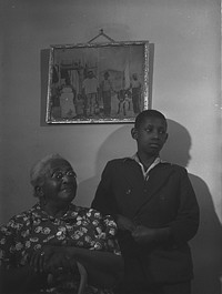 Mrs. Ella Patterson, the oldest resident at the Ida B. Wells Housing Project, Chicago, Illinois, and her grandson. She is 102 years old. Sourced from the Library of Congress.