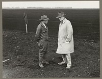 Stockton, Calif. Apr. 1942. Henry [i.e., Harry] T. Futamachi, left, superintendant of a 1300-acre mechanized ranch, discussing agricultural problems with the ranch owner, John B. MacKinley. Before evacuation of persons of Japanese ancestry, Futamachi, 45, was paid $4000 a year and bonuses. He came to the United States 28 years ago with his father. He will be sent to a War Relocation Authority center for the duration of the war. Sourced from the Library of Congress.