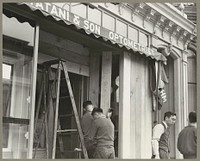 San Francisco, Calif. Apr. 1942. Owners boarding up windows of their stores on Post Street prior to their evacuation as persons of Japanese ancestry. The evacuees will be housed in War Relocation Authority centers for the duration of the war. Sourced from the Library of Congress.
