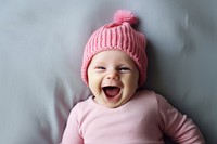 Baby laughing pink bed. 