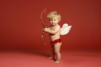 Holding cupid baby bow. 