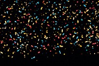 Confetti backgrounds black background illuminated. 