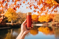 Autumn cosmetics holding bottle. 