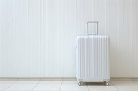 Suitcase luggage white wall. 