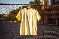 T-shirt sleeve yellow fence. 