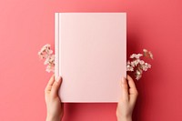 Book pink hand publication. AI generated Image by rawpixel.
