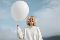 Balloon outdoors holding adult. 