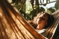 Woman napping on hammock. 