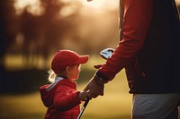 Dad playing golf with son. 