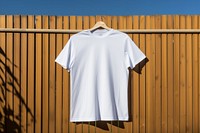 T-shirt sleeve white fence. 