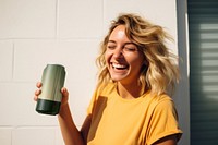 Happy woman holding soda can