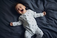 Baby laughing yawning bed. 