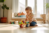 A colorful wooden toy car a male toddler playing baby construction. 