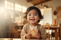 Filipino toddler eating cracker baby food happiness. 