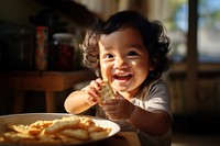 Filipino toddler eating cracker In kitchen food baby skin. AI generated Image by rawpixel.