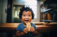 Filipino toddler eating cracker portrait photo food. 