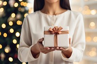 Christmas holding gift tree. AI generated Image by rawpixel.